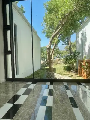 a room with a window and a checkered floor at Mountain Cottages at Haskell Vineyard in Stellenbosch