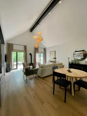 a living room with a table and a couch at Mountain Cottages at Haskell Vineyard in Stellenbosch