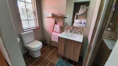 a small bathroom with a toilet and a sink at House of Perez in Wellington