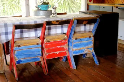 a kitchen with two colorful chairs at a counter at House of Perez in Wellington
