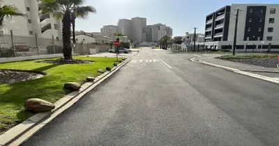 an empty street in a city with a stop sign at 2 Bedroom Oceanfront Apartment with Sea Views in Cape Town
