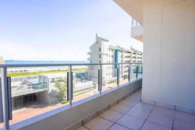 an apartment balcony with a view of the ocean at 2 Bedroom Oceanfront Apartment with Sea Views in Cape Town