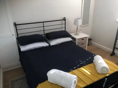 a bedroom with a large bed with two pillows at Whale Rock Estate Hermanus sea view apartment in Hermanus