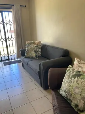 a living room with a couch at SEASCAPE MEWS 27 in Cape Town