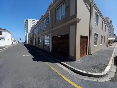 a building on the side of a street at Cozy Strand Beach Getaway - Studio Apartment in Cape Town