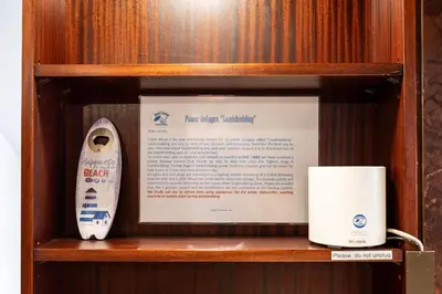 a wooden shelf with a surfboard next to a mug at Beach2Anchor, Beachfront 4 bedroom condo with Jacuzzi in Gordonʼs Bay
