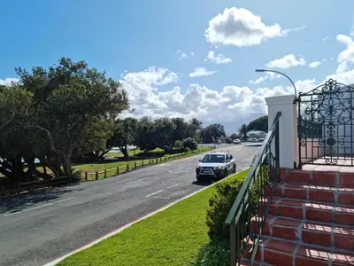 a car is driving down a street at Milkwood Cottage, Beachfront family vacation home, Sleeps 6 in Gordonʼs Bay