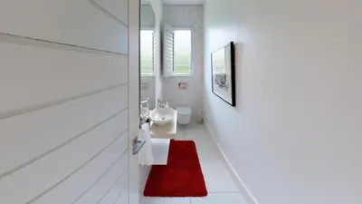 a bathroom with a sink and a red rug at Stamford on Sea by Top Destinations Rentals in Hermanus