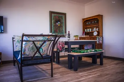 a room with a table and a chair and a table and a bench at 41 on Siffie in Hermanus