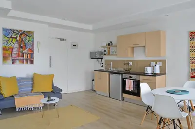 a kitchen and living room with a couch and a table at 108 Waverley in Cape Town
