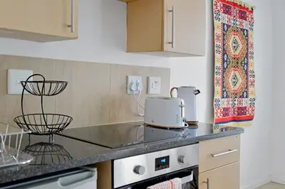 a kitchen with a counter top with a sink at 108 Waverley in Cape Town