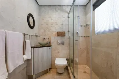 a bathroom with a toilet and a glass shower at Luxury Witsand 706 in Cape Town
