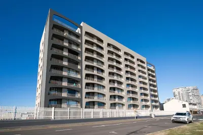 a tall building with a car parked in front of it at Luxury Witsand 706 in Cape Town
