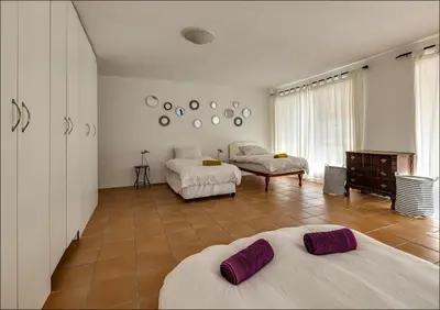 a bedroom with two beds and a large window at Seaclusion in Hermanus