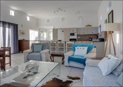 a living room with two chairs and a table at Seaclusion in Hermanus