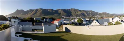 a view of a town with mountains in the background at Seaclusion in Hermanus