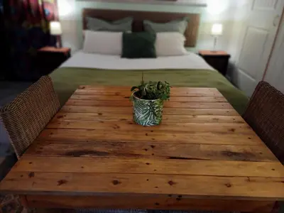 a wooden table with a potted plant on top of a bed at The Farmhouse B&B in Stellenbosch