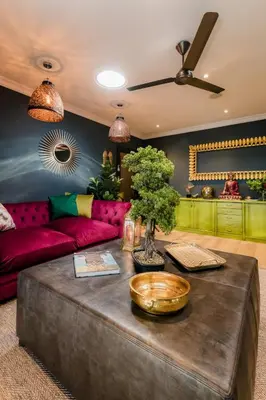a living room with a couch and a table at SW1 Lodge in Somerset West