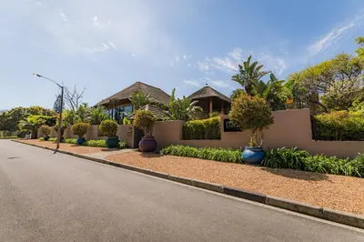 a street with a row of houses with plants at SW1 Lodge in Somerset West