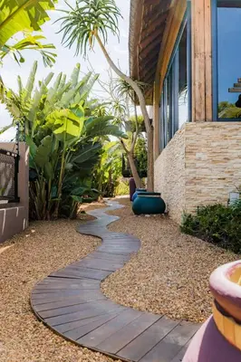 a garden with a walkway next to a building at SW1 Lodge in Somerset West