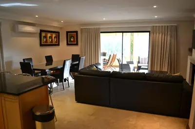 a living room with a couch and a dining room at Pearl Valley-Golf Safari SA in Paarl
