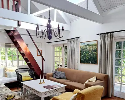 a living room with a couch and a table at Porcupine Hills Olive and Guest Farm in Botrivier