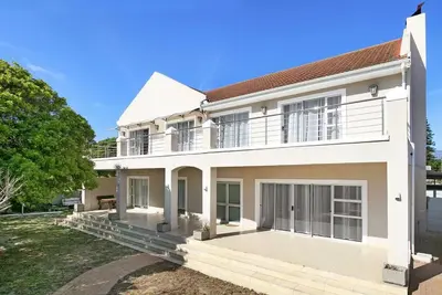 a large white house with a large patio at Prestigious Guest Villa in Cape Town