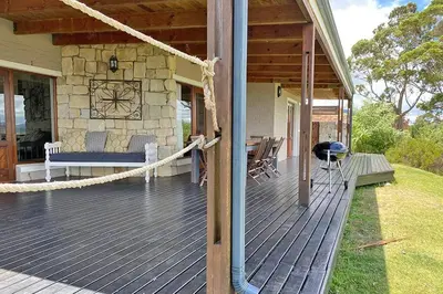 a porch of a house with a hammock on it at Lagoon View in Hermanus in Hermanus