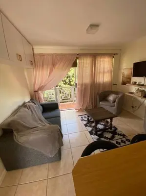 a living room with a couch and a chair at Hermanus Beach Club 31 in Hermanus
