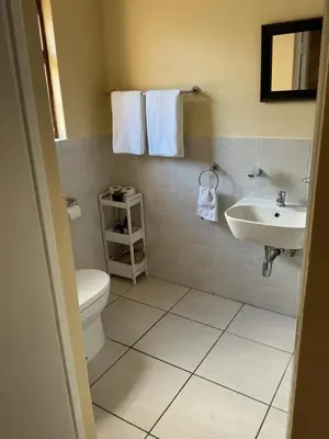 a bathroom with a toilet and a sink at Classic Cape Dutch Studio Apartment in Cape Town