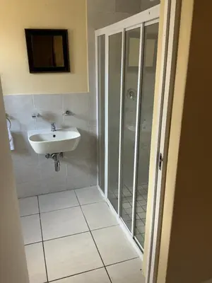 a bathroom with a sink and a shower at Classic Cape Dutch Studio Apartment in Cape Town
