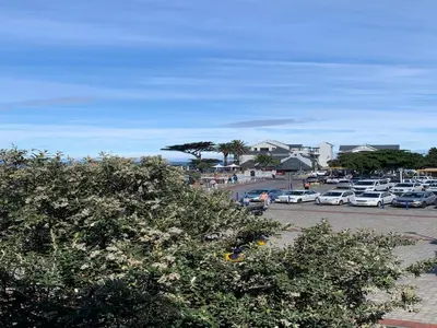 a parking lot with cars parked in a parking lot at Hermanus Waterfront Apartment in Hermanus