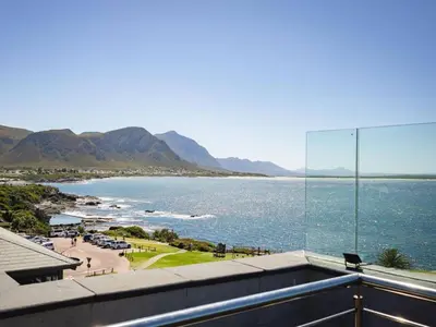 a view of the ocean from the balcony of a house at Hermanus Waterfront Apartment in Hermanus