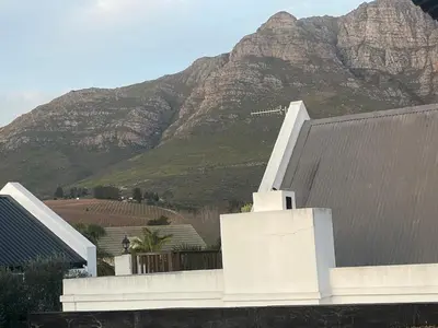 a house with a mountain in the background at Paradyskloof Suite in Stellenbosch