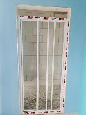 a sliding glass door with red and white stripes at Hasate Guest House ,4 st james street Oakdale Belliville Cape Town South Africa in Cape Town