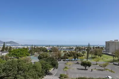 a view of a park with trees and the ocean at 2 Bedroom Secure Pool Strong WiFi in Cape Town