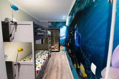 a childs room with a ocean themed wall at The Butterfly Villa in Pringle Bay