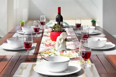 a wooden table with wine glasses and a table cloth at Knightsbridge Terrace in Cape Town