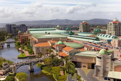 a city with a bridge and buildings and a river at Knightsbridge Terrace in Cape Town