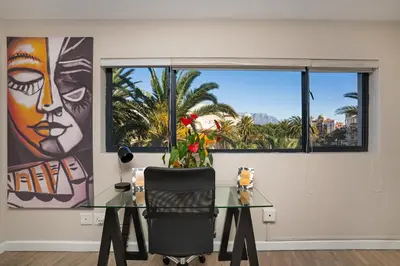 an office with a glass table and a window at Knightsbridge Terrace in Cape Town