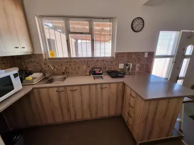 a kitchen with a counter and a sink and a microwave at The Ridge in Cape Town