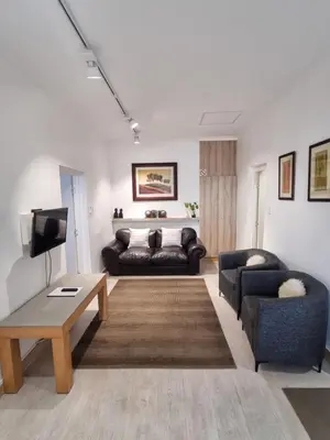 a living room with a couch and a table at The Ridge in Cape Town