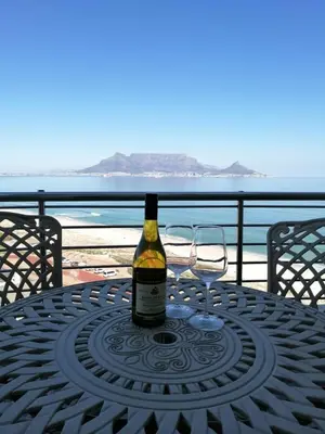a bottle of wine sitting on top of a table at Blouberg,1106 Portico,Cape town in Cape Town