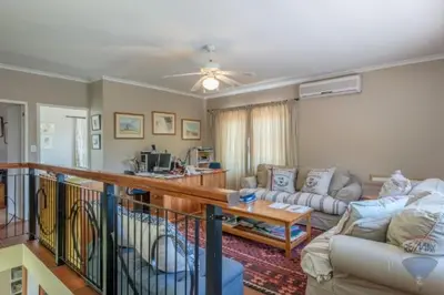 a living room with a couch and a table at Tuscany Hauss Villa in Somerset West