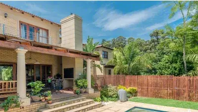 a house with a fence in front of it at Tuscany Hauss Villa in Somerset West