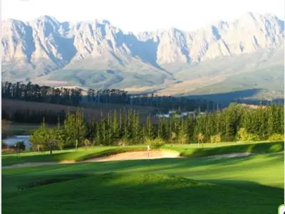 a view of a golf course with mountains in the background at Tuscany Hauss Villa in Somerset West