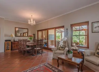 a living room with a couch and a table at Tuscany Hauss Villa in Somerset West