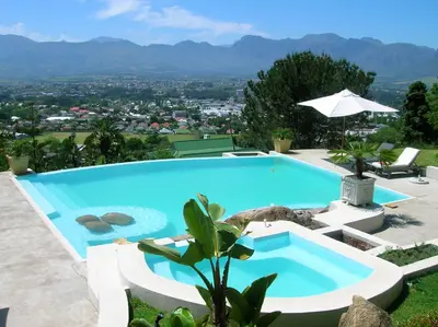 a swimming pool with a view of the mountains at Perle Du Cap in Paarl