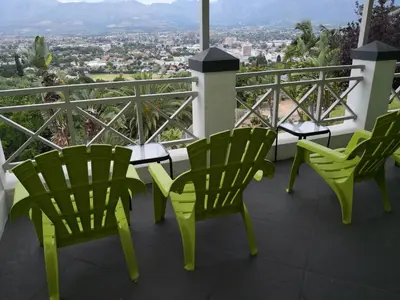a group of chairs on a balcony with a view at Perle Du Cap in Paarl