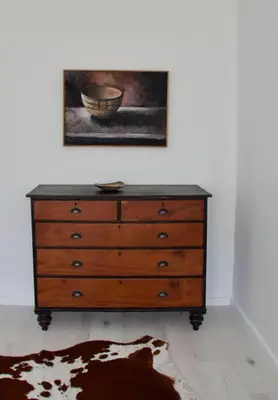 a dresser in a room with a painting on the wall at Seafront house with a view in Kleinmond